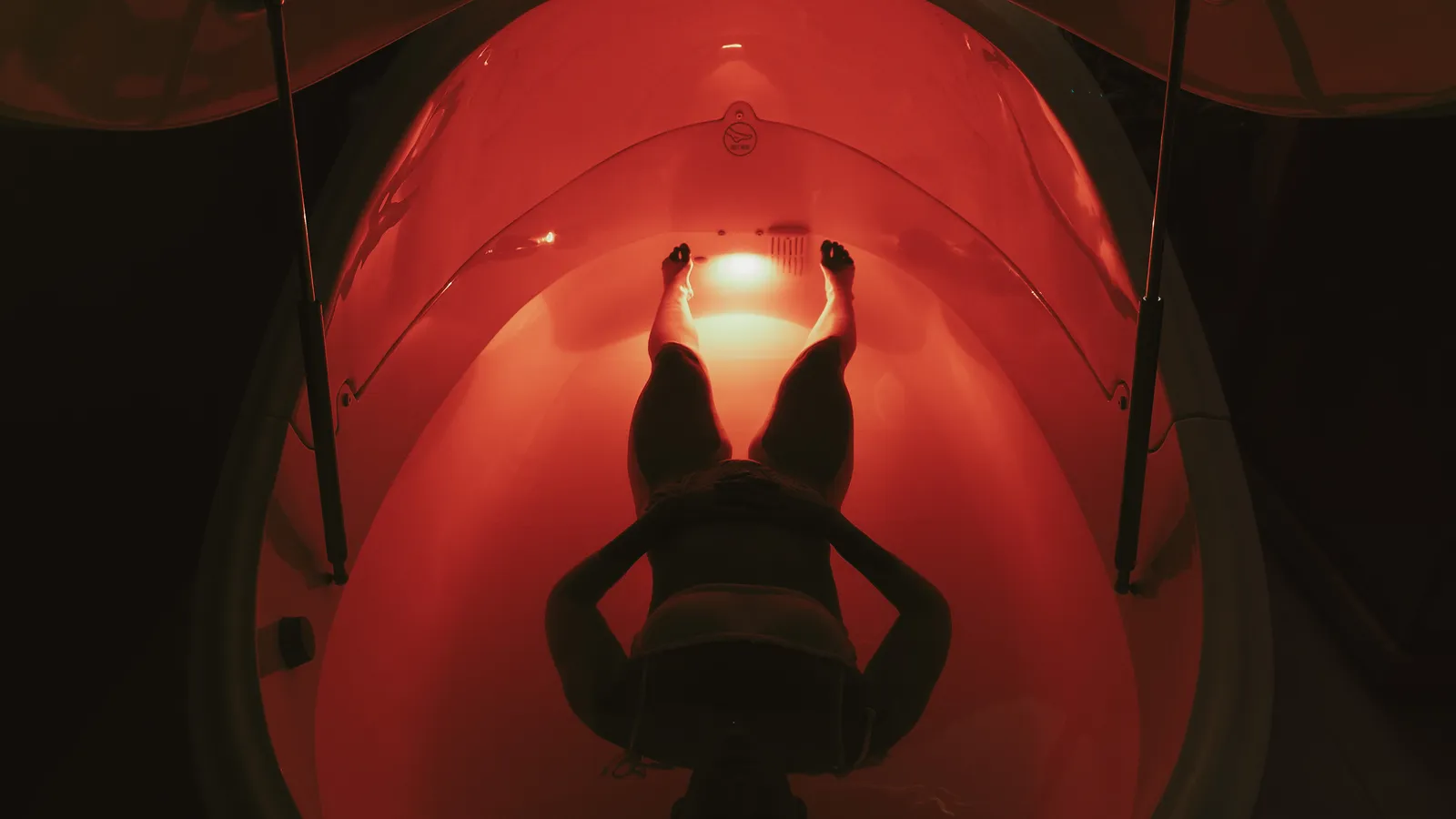 Aerial view of a float pod bathed in red light at Davaar House